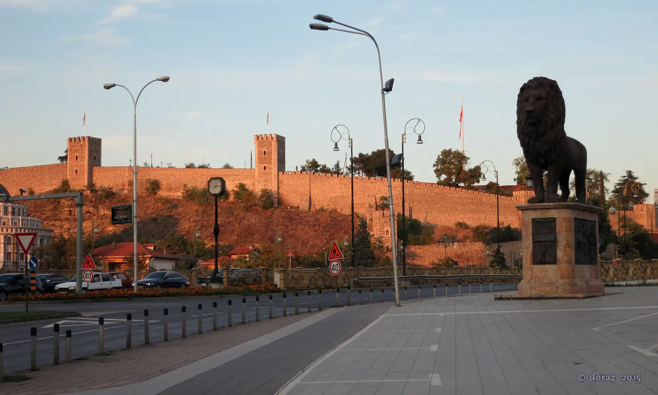 Kale Fortress walls glowing in late-afternoon light above central Skopje